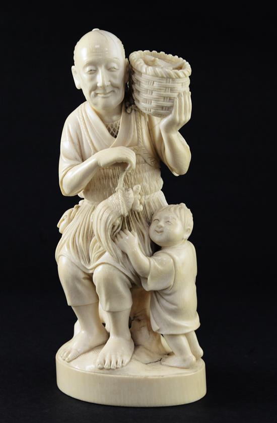 A Japanese ivory group of a fisherman and a boy, early 20th century, 13.5cm, age cracks